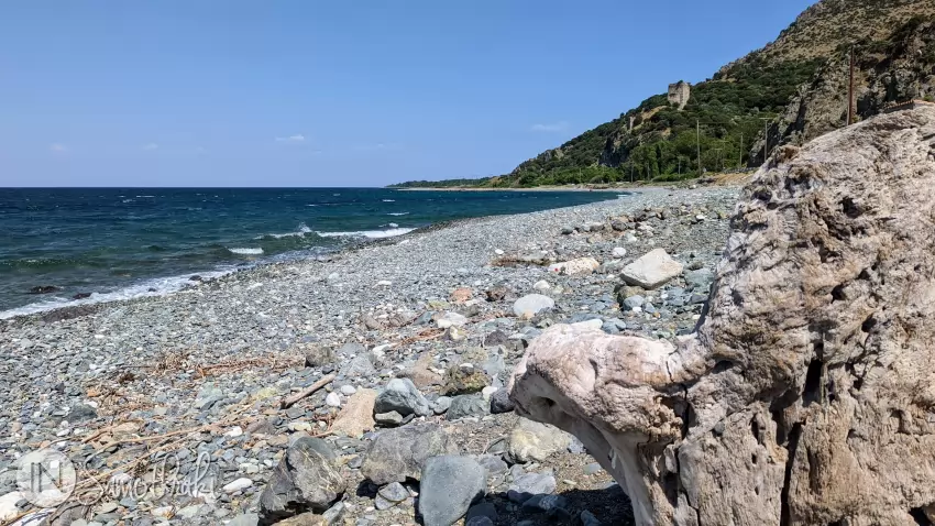 Plaja este cu pietriș, fiind dominată &icirc;ntr-o parte de ruinele turnurilor medievale.
